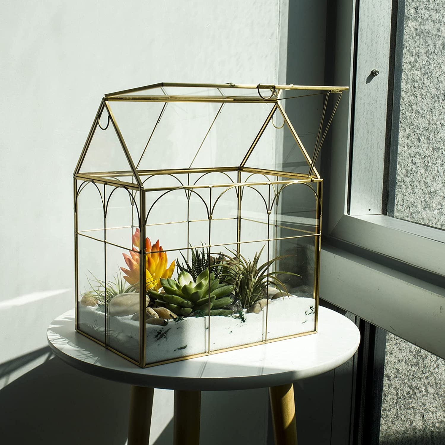 House-shaped glass terrarium with gold frame