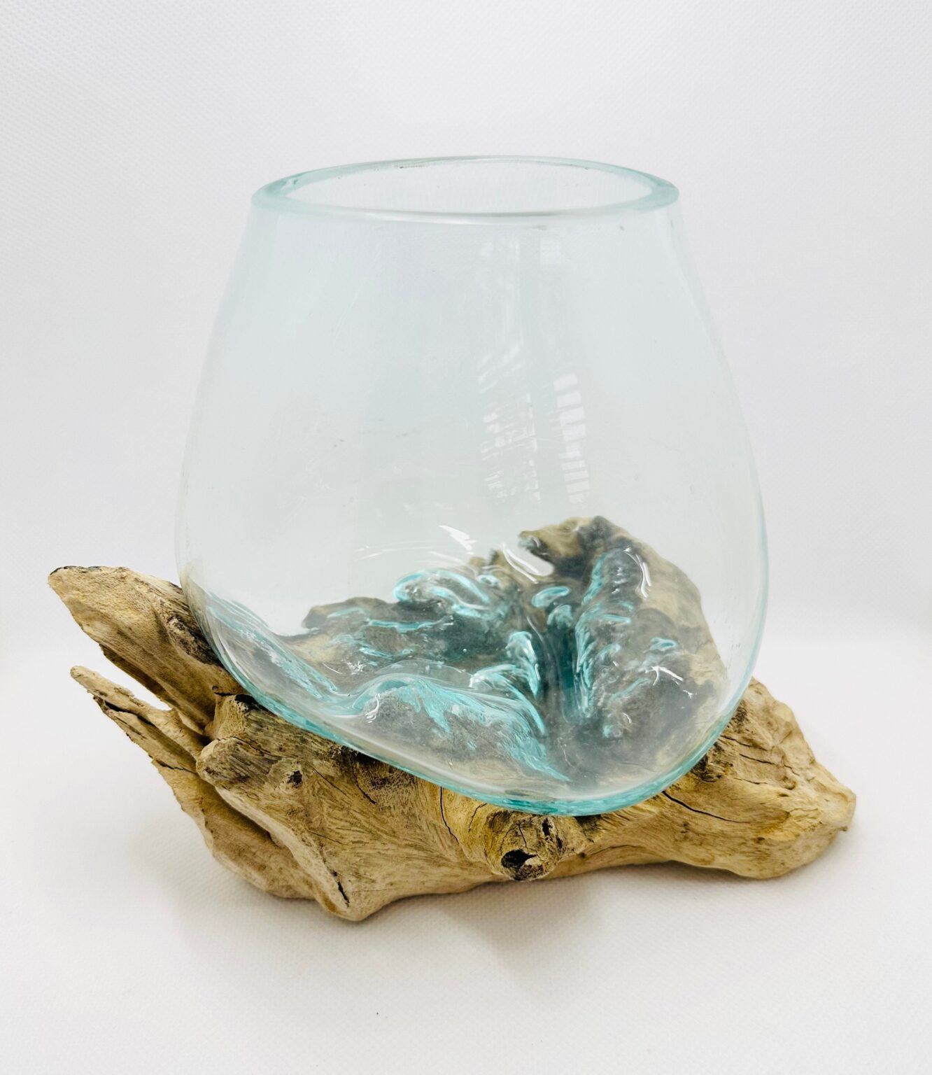 A hand-blown glass terrarium on a driftwood base, in the artisan style of a MOSSCAPES Lamparium