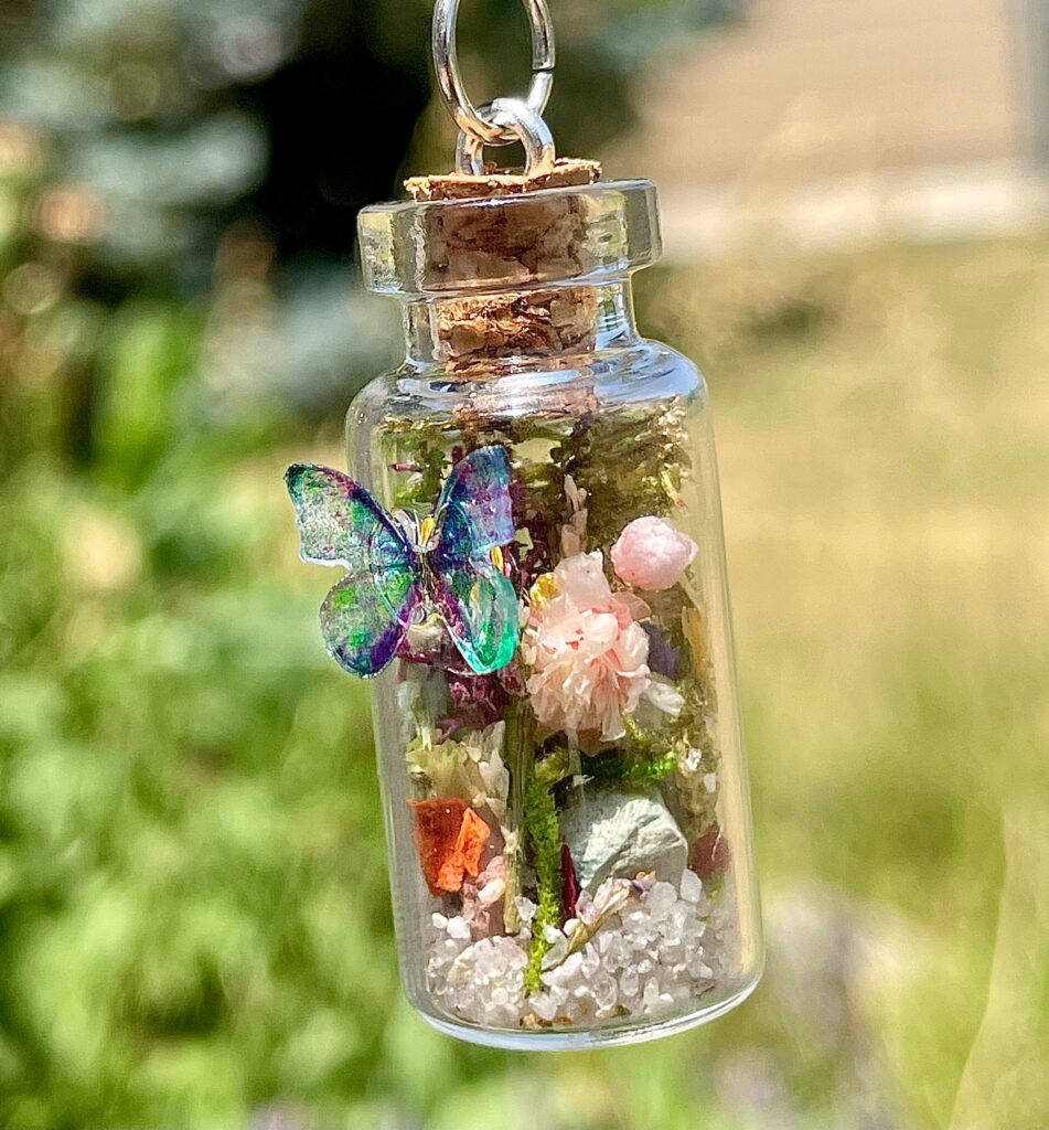 Terrarium-style pendant necklace with preserved moss and flowers